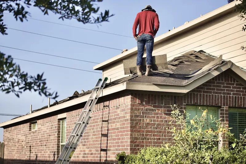 Professional roofer working on a residential roof in Manorhaven